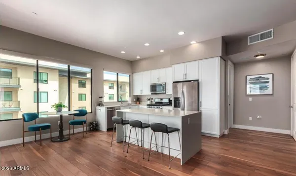 a kitchen with sink refrigerator and large window