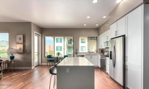 a kitchen with a sink a refrigerator and a stove top oven