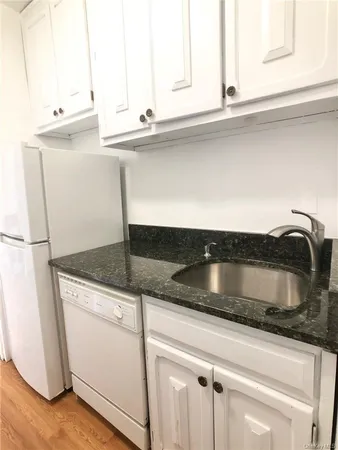 a stove top oven sitting inside of a kitchen