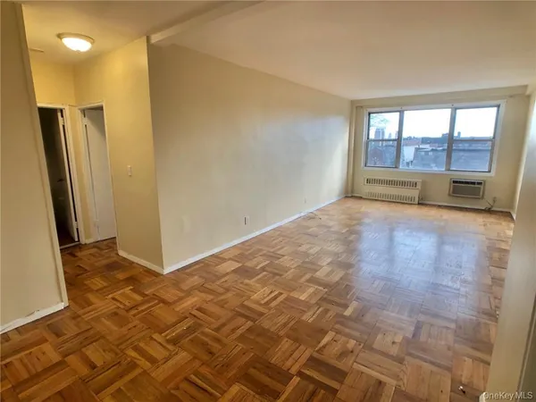 a view of an empty room and a window