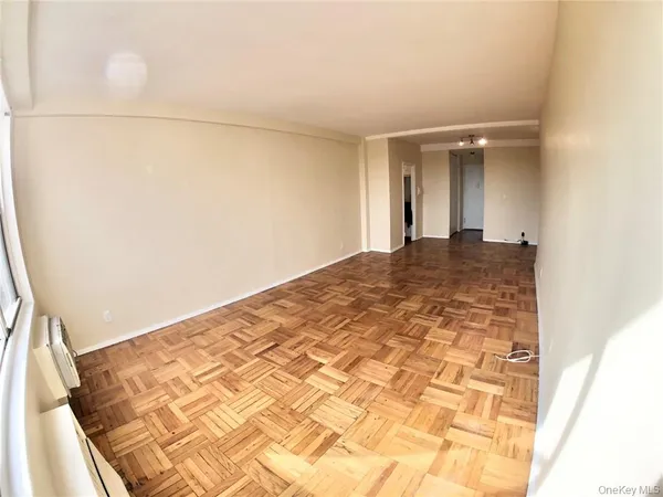 a view of a hallway with wooden floor and closet
