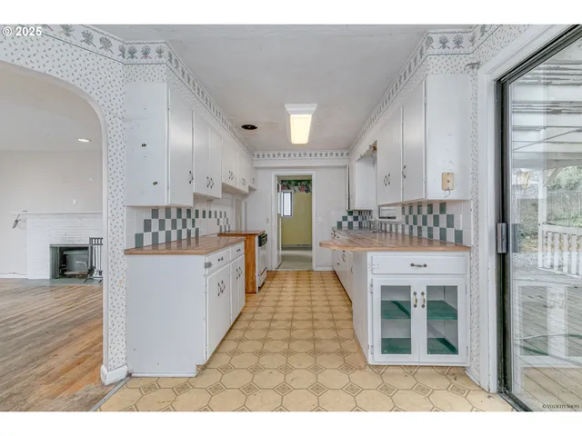 a kitchen with stainless steel appliances kitchen island granite countertop a refrigerator and a stove top oven