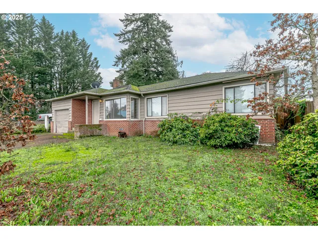 a view of a house with yard and a garden