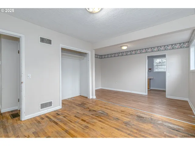 a view of an empty room and wooden floor