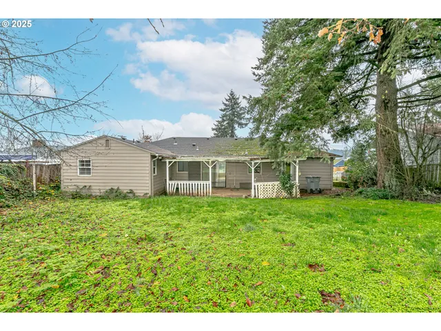 a view of a house with a backyard