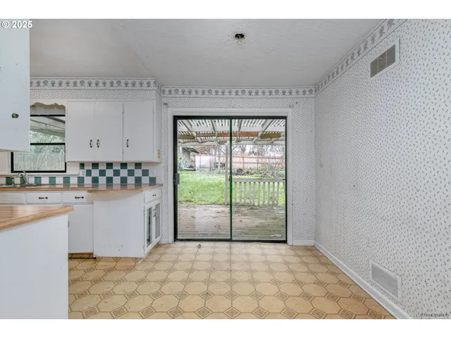 a view of open kitchen with granite countertop cabinets