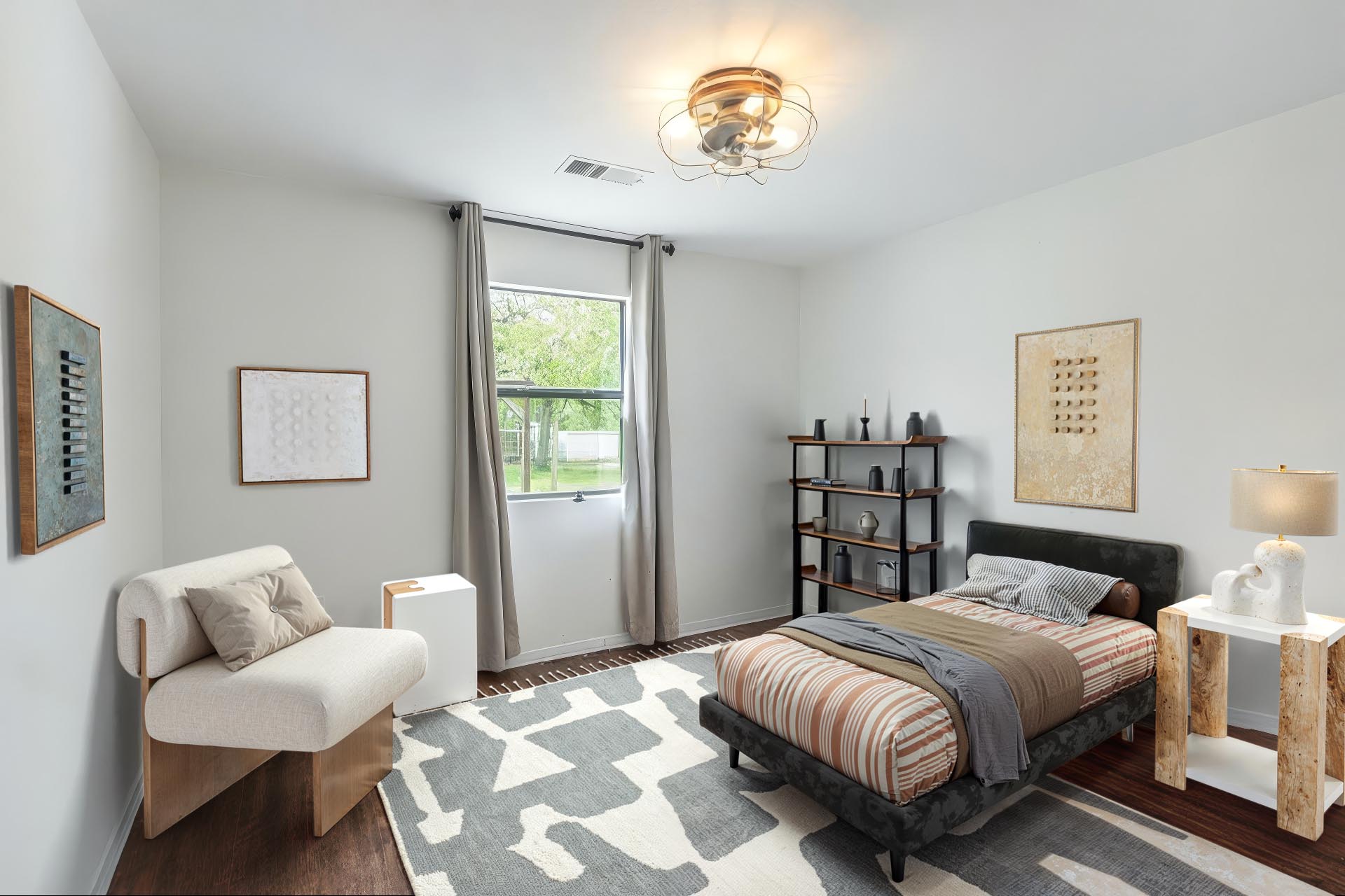 326 Zapalac Road Smithville, TX 78957 - Photo 6 of 8 a spacious bedroom with a bed and a chandelier