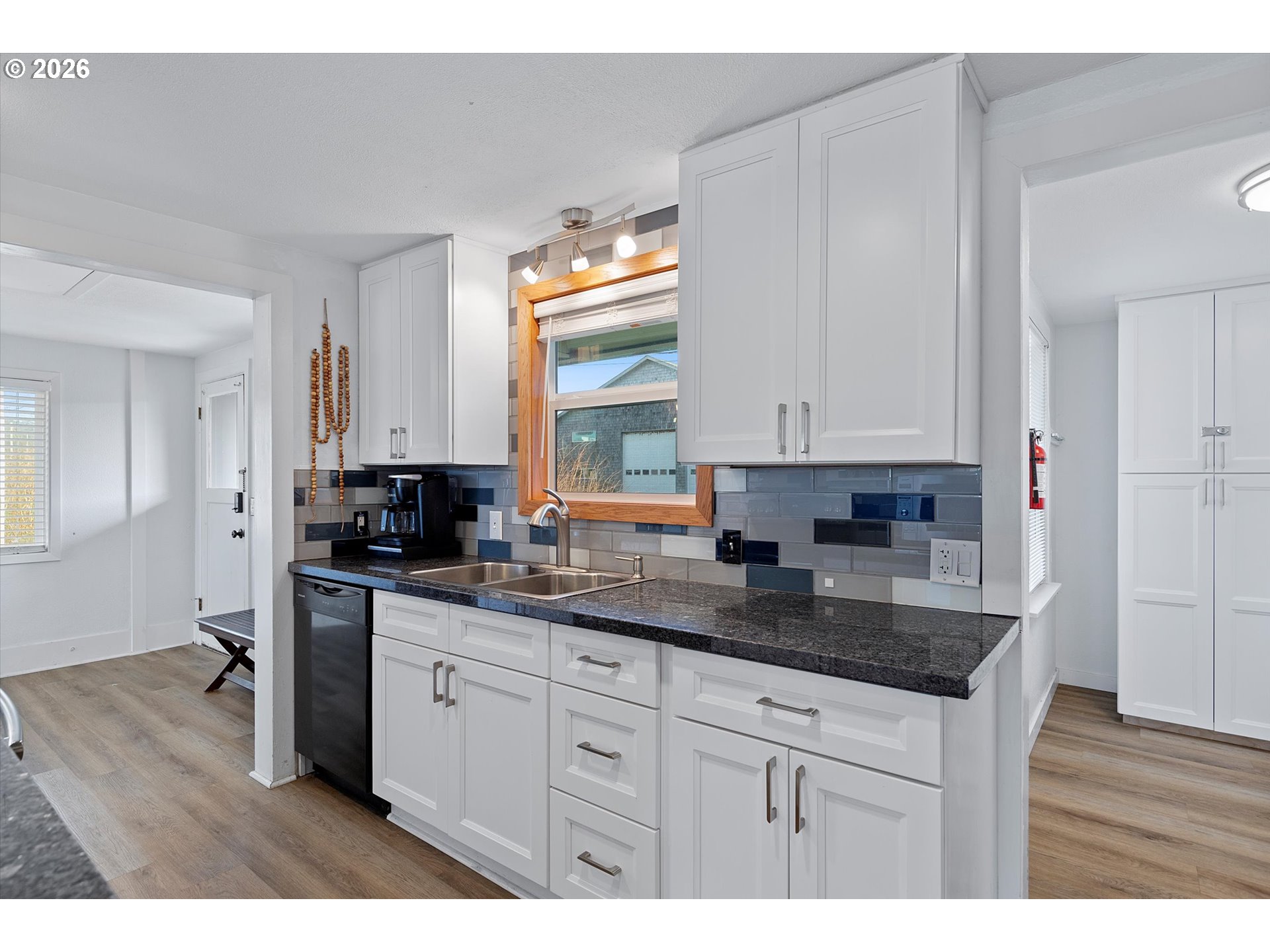 35160 Rueppel Avenue Pacific City, OR 97135 - Photo 11 of 34 a kitchen with stainless steel appliances granite countertop a sink a stove and wooden floors
