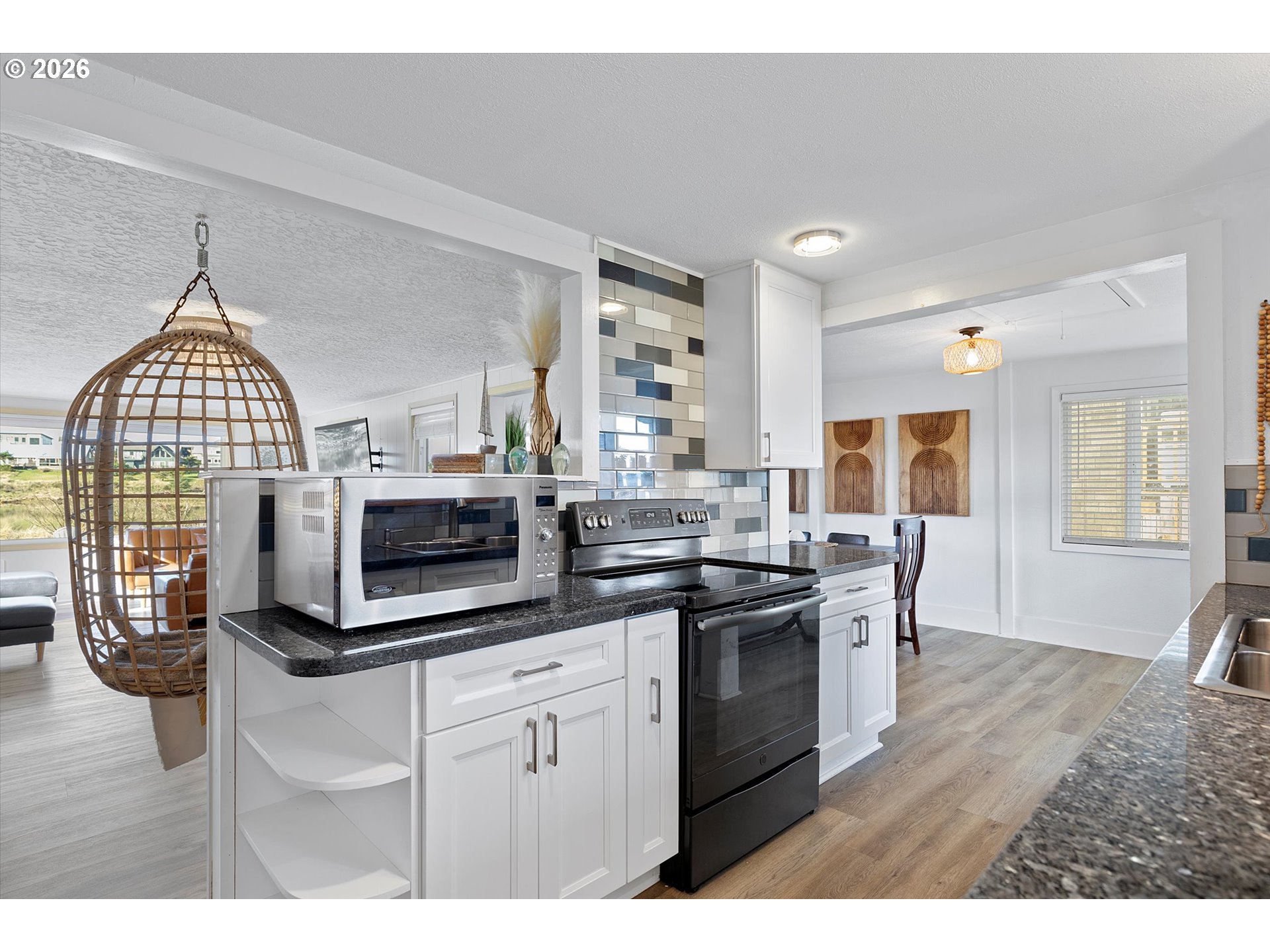 35160 Rueppel Avenue Pacific City, OR 97135 - Photo 12 of 34 a kitchen with stainless steel appliances kitchen island granite countertop a stove a sink and a microwave