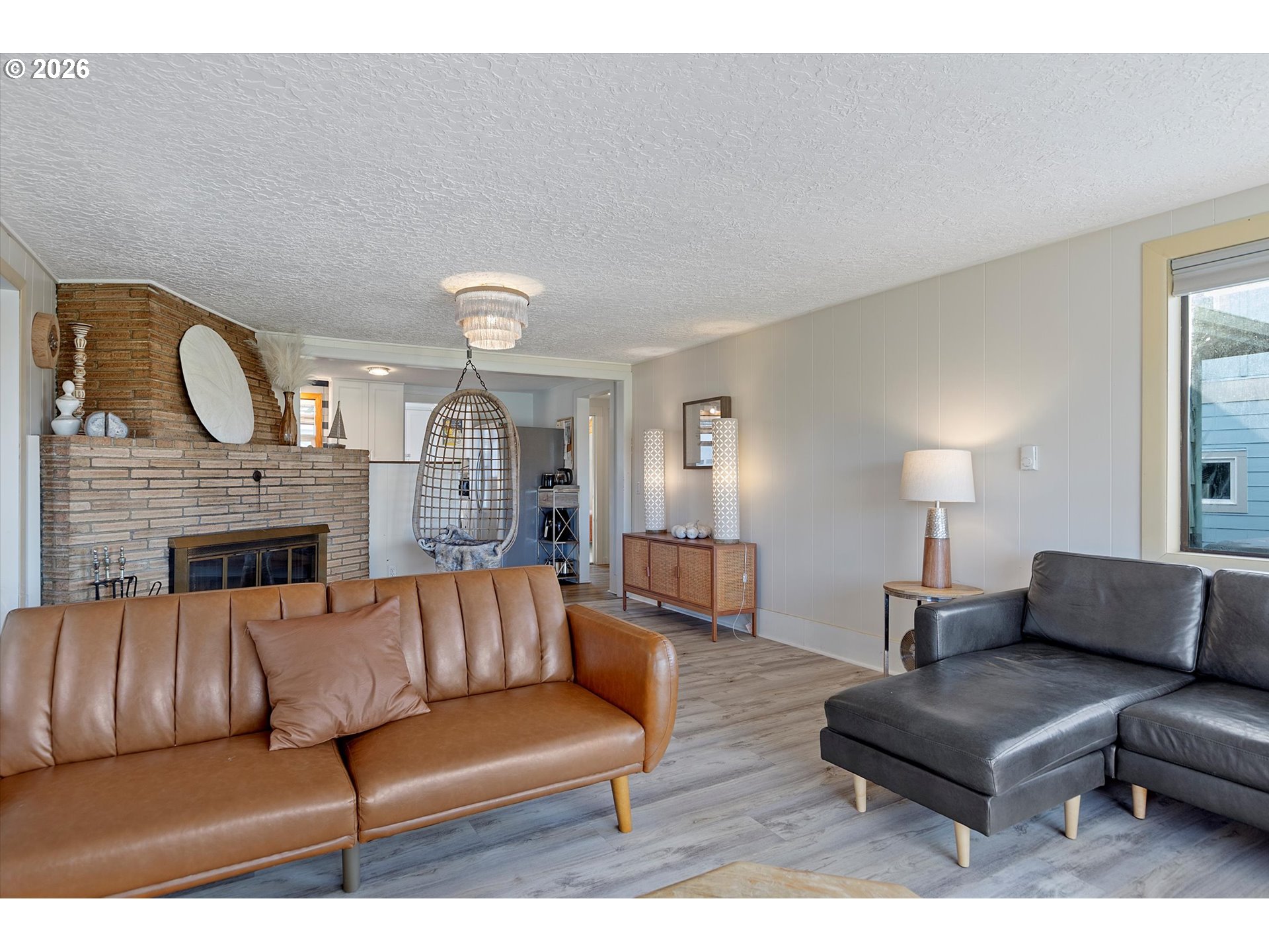 35160 Rueppel Avenue Pacific City, OR 97135 - Photo 8 of 34 a living room with furniture a fireplace and a chandelier