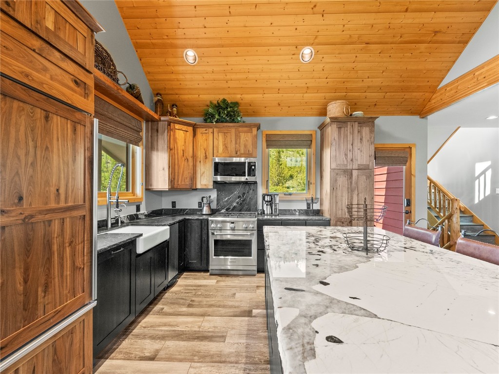 89 Emerald Road Silverthorne, CO 80498 - Photo 11 of 46 a kitchen with stainless steel appliances kitchen island granite countertop a sink and cabinets