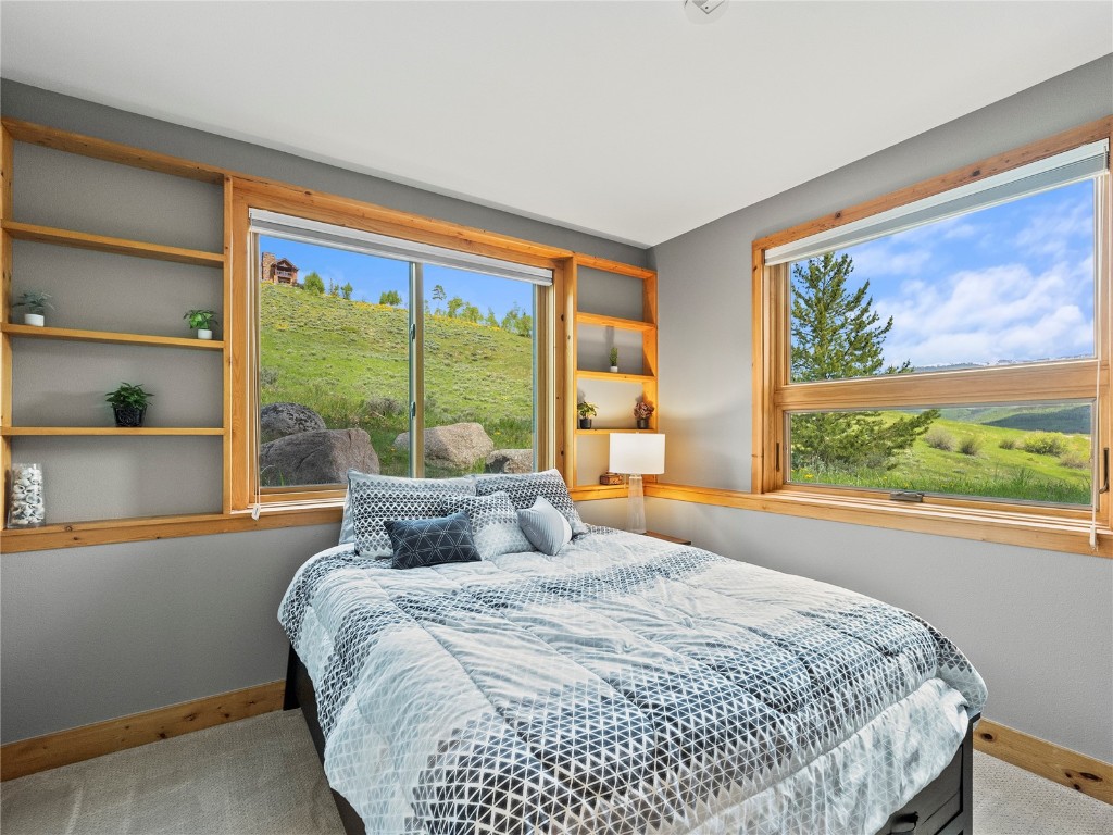 89 Emerald Road Silverthorne, CO 80498 - Photo 20 of 46 a bedroom with a large window and a bed