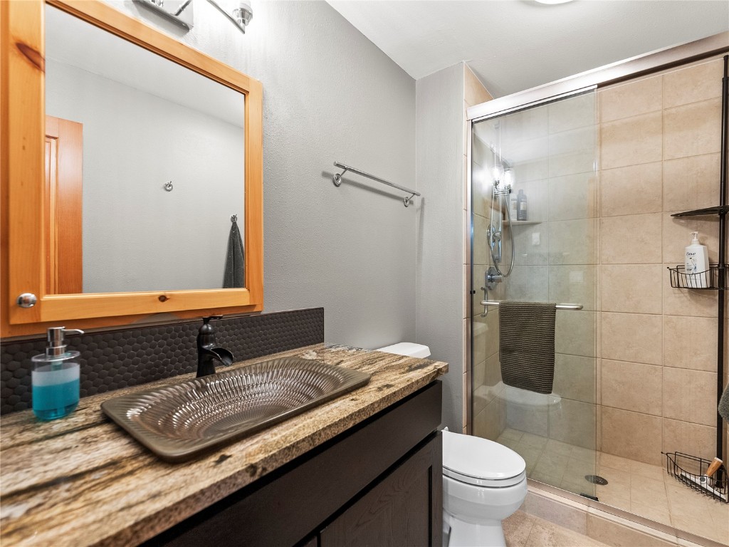 89 Emerald Road Silverthorne, CO 80498 - Photo 23 of 46 a bathroom with a granite countertop sink toilet and shower