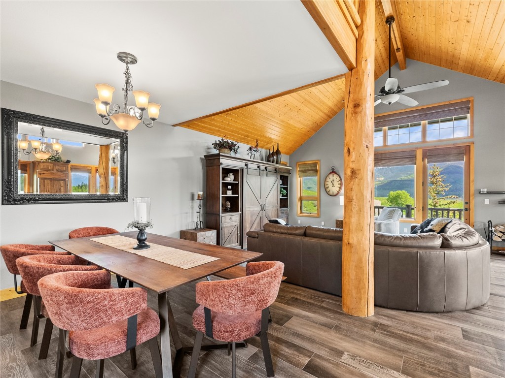 89 Emerald Road Silverthorne, CO 80498 - Photo 8 of 46 a dining room with wooden floor a chandelier a wooden table and chairs