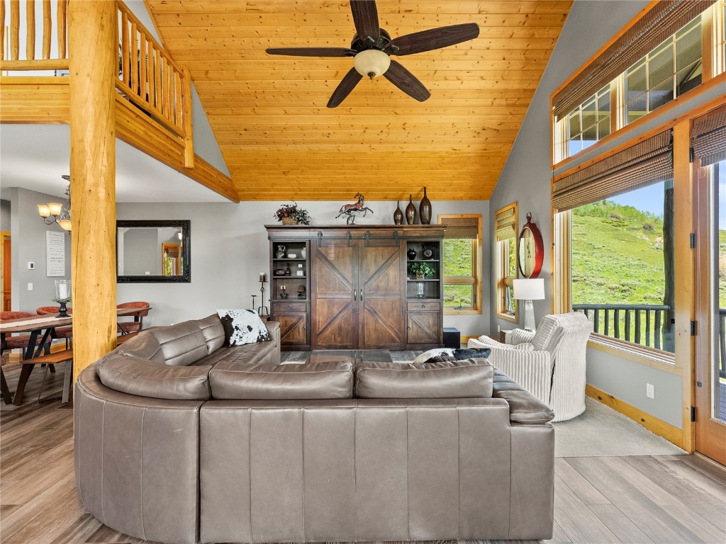 89 Emerald Road Silverthorne, CO 80498 - Photo 9 of 46 a living room with fireplace furniture and a floor to ceiling window