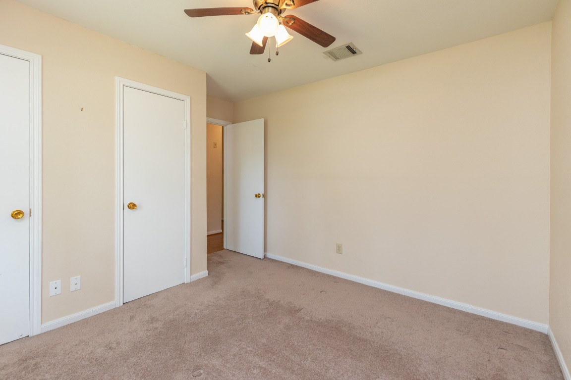 2623 Longleaf Pines Lane Houston, TX 77339 - Photo 25 of 32 an empty room with a ceiling fan and a window