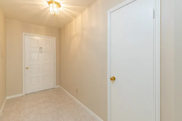an empty room with chandelier fan