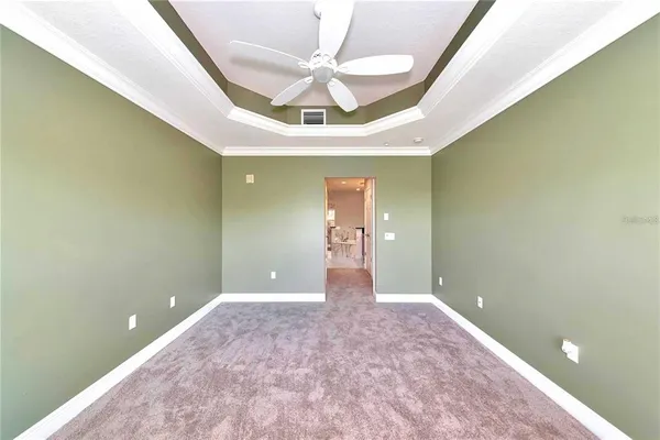 a view of a livingroom with a ceiling fan and window