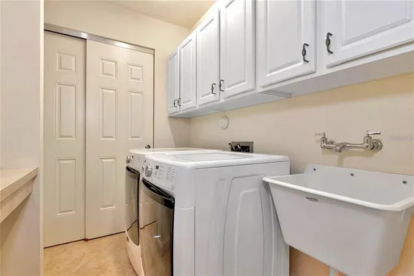 a utility room with a sink dryer and washer