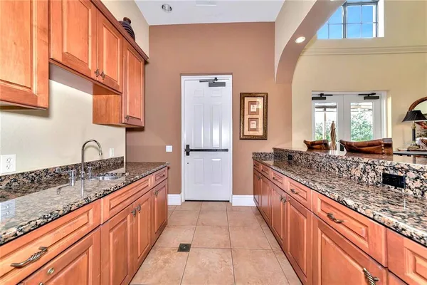 a large kitchen with stainless steel appliances granite countertop a sink stove and cabinets