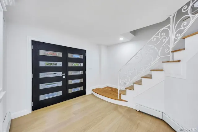 a view of a kitchen with a sink and a refrigerator