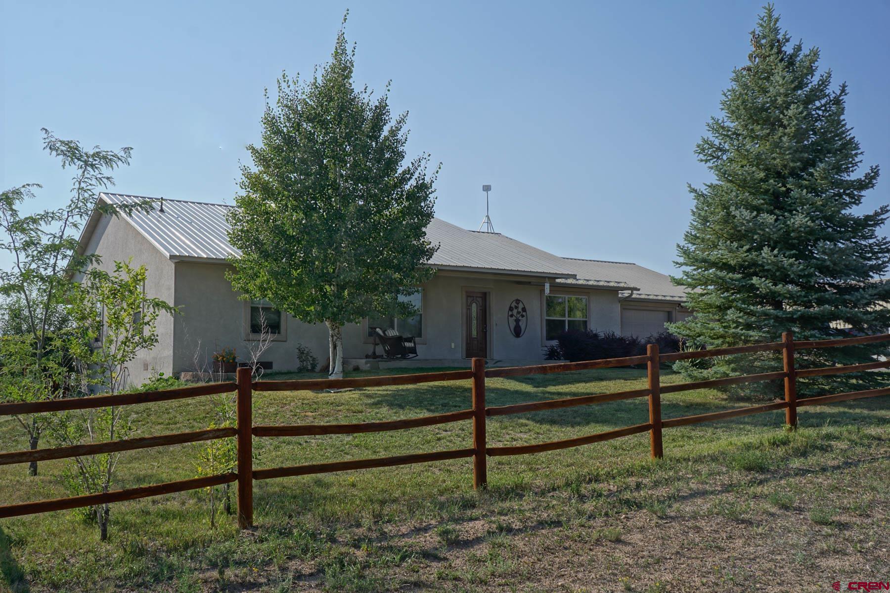 16575 2550th Road Cedaredge, CO 81413 - Photo 1 of 32 a front view of a house with a garden