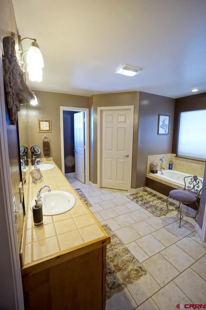 16575 2550th Road Cedaredge, CO 81413 - Photo 15 of 32 a bath room with a bed and furniture