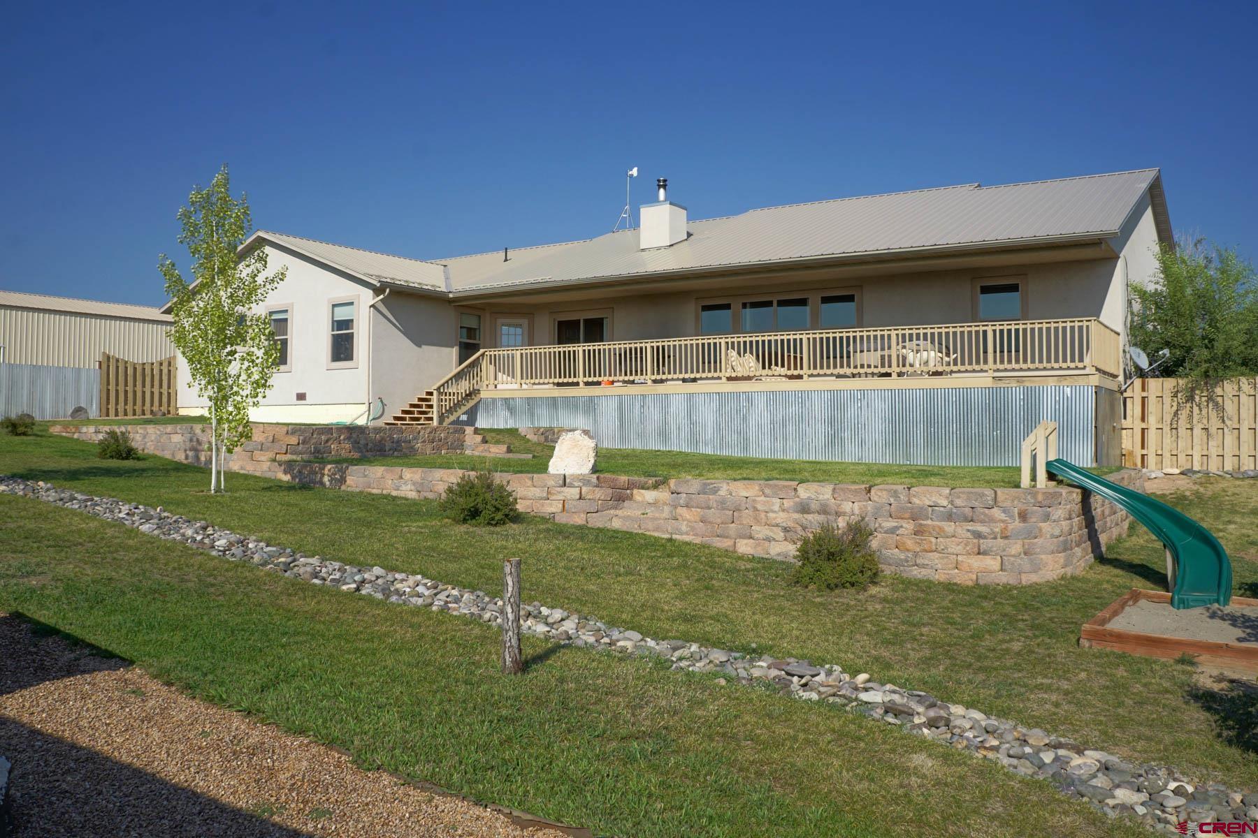 16575 2550th Road Cedaredge, CO 81413 - Photo 26 of 32 a front view of a house with a yard
