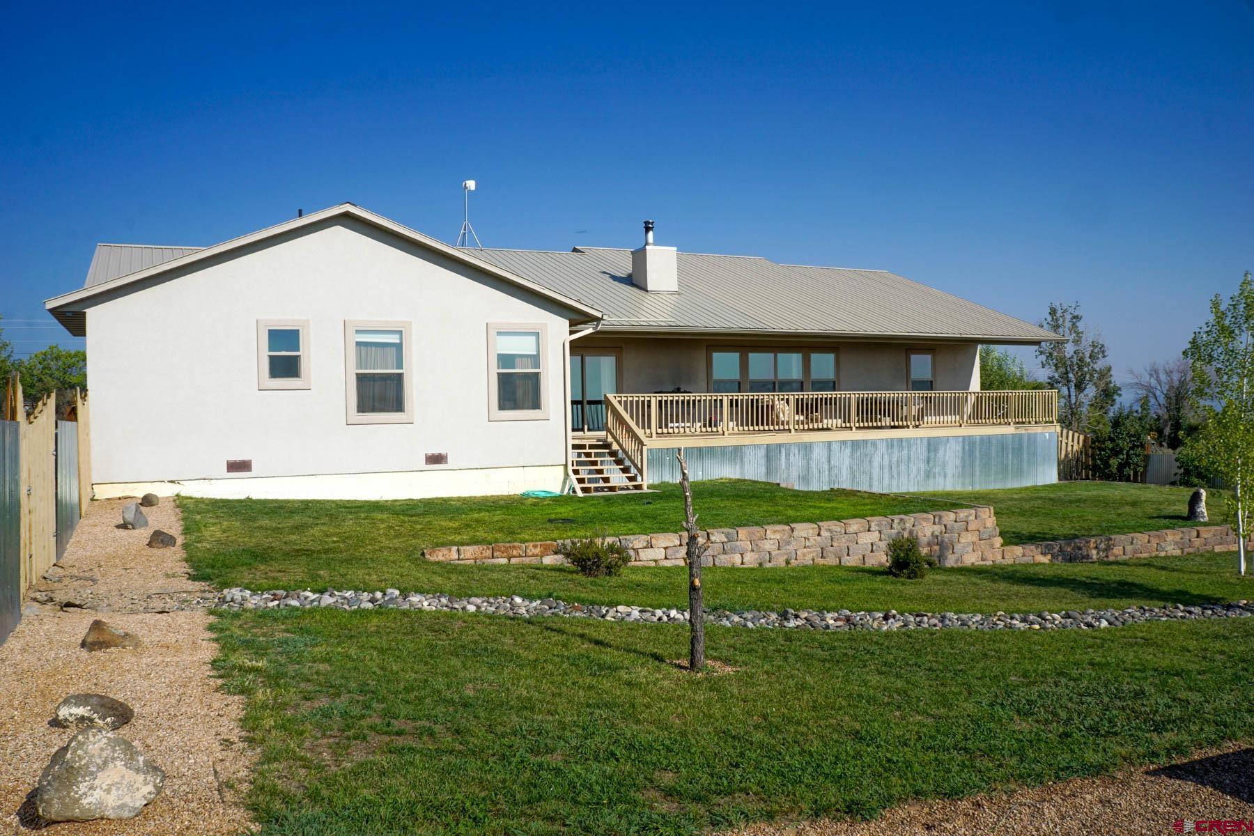 16575 2550th Road Cedaredge, CO 81413 - Photo 28 of 32 a front view of a house with a yard
