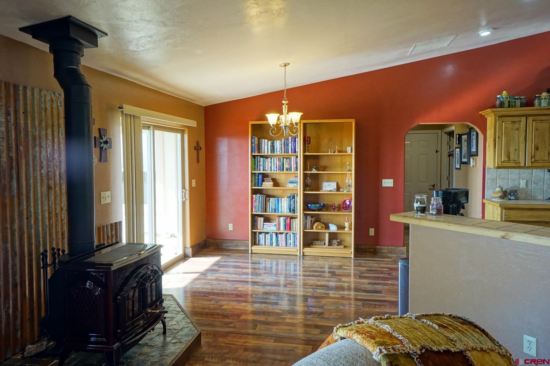 16575 2550th Road Cedaredge, CO 81413 - Photo 6 of 32 a bedroom with a bed and a bookshelf