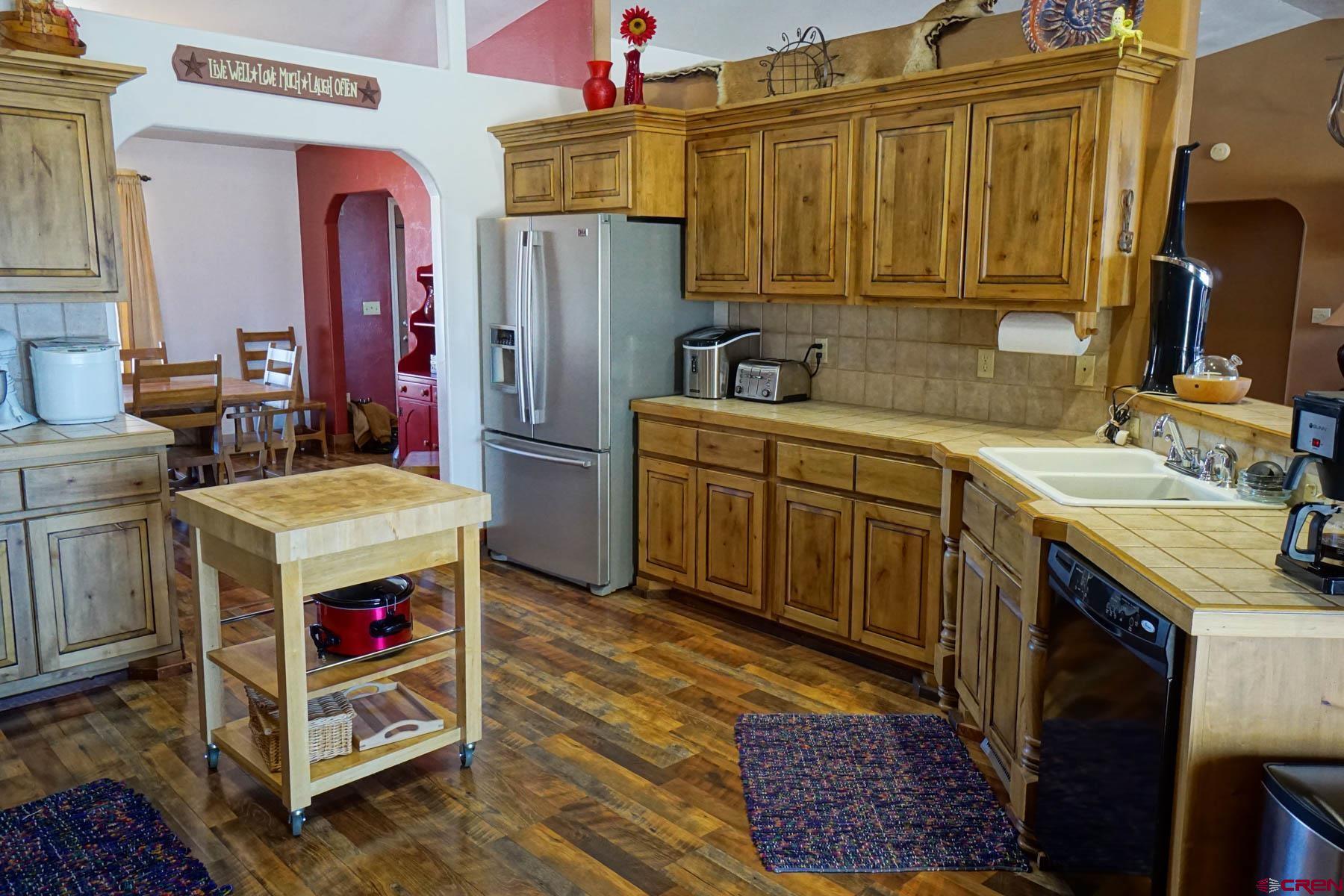 16575 2550th Road Cedaredge, CO 81413 - Photo 8 of 32 a utility room with a stove a washer and dryer