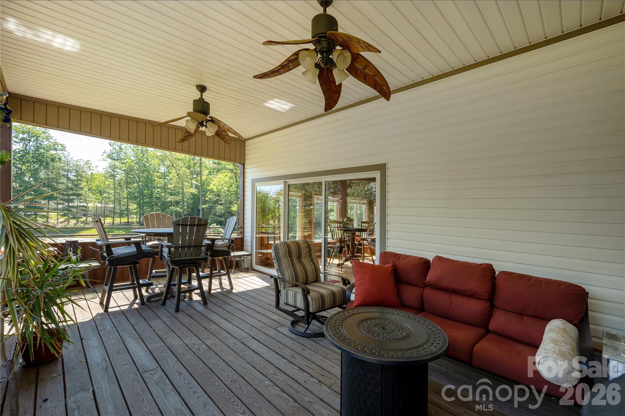 231 Allen Road East Flat Rock, NC 28726 - Photo 29 of 42 a living room with furniture a ceiling fan and a large window