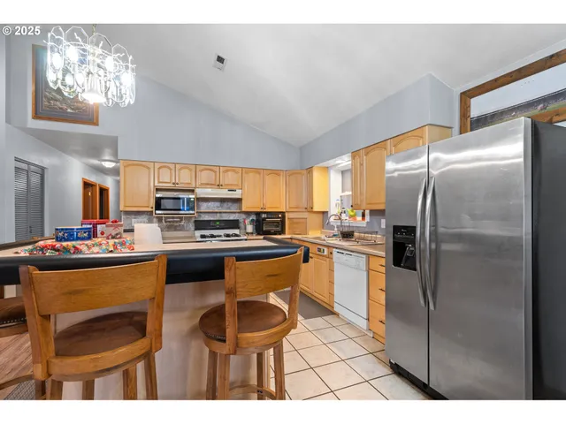a kitchen with refrigerator and cabinets