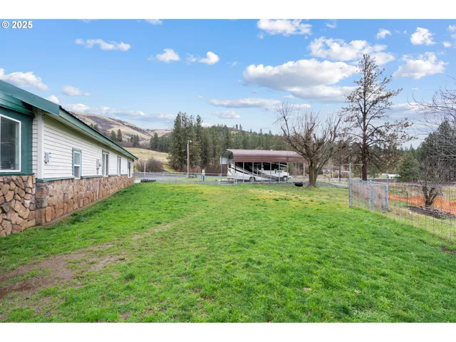 a view of a house with a backyard porch and sitting area