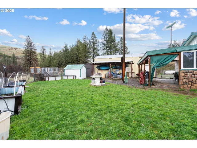 a view of a patio with table and chairs under an umbrella