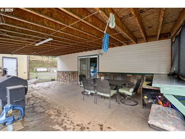 a backyard of a house with table and chairs