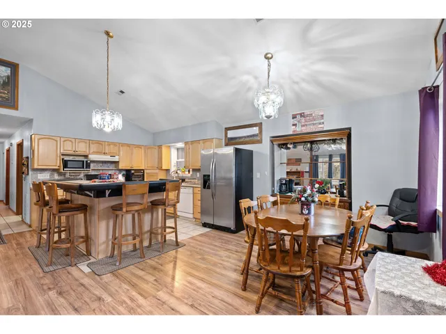 a view of a dining room with furniture and chandelier