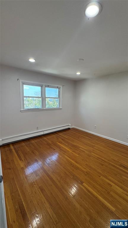 85 Eastern Way Rutherford, NJ 07070 - Photo 18 of 23 an empty room with wooden floor and windows
