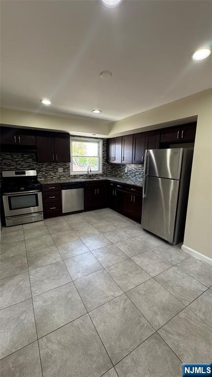 85 Eastern Way Rutherford, NJ 07070 - Photo 7 of 23 a large kitchen with kitchen island granite countertop a stove top oven a sink a counter space and cabinets