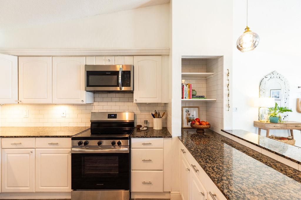 112 Drake Road St. Augustine, FL 32086 - Photo 11 of 59 a kitchen with a stove and a white cabinets