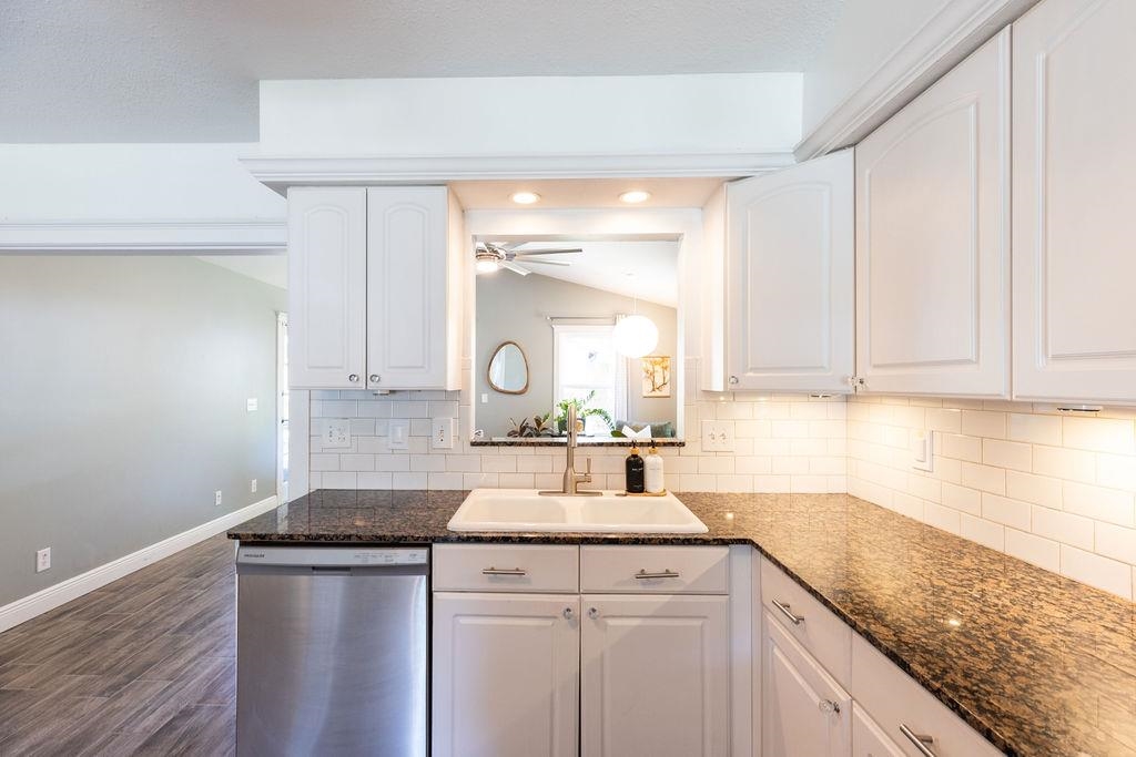 112 Drake Road St. Augustine, FL 32086 - Photo 12 of 59 a kitchen with stainless steel appliances granite countertop a sink stove and cabinets