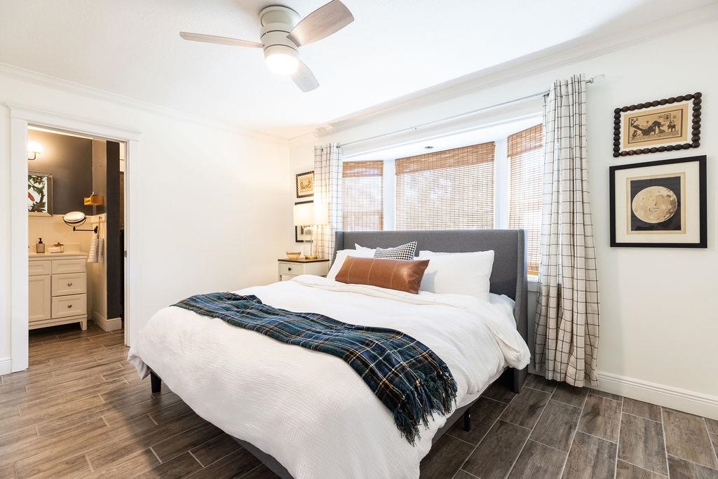 112 Drake Road St. Augustine, FL 32086 - Photo 28 of 59 a bedroom with a bed and a chandelier