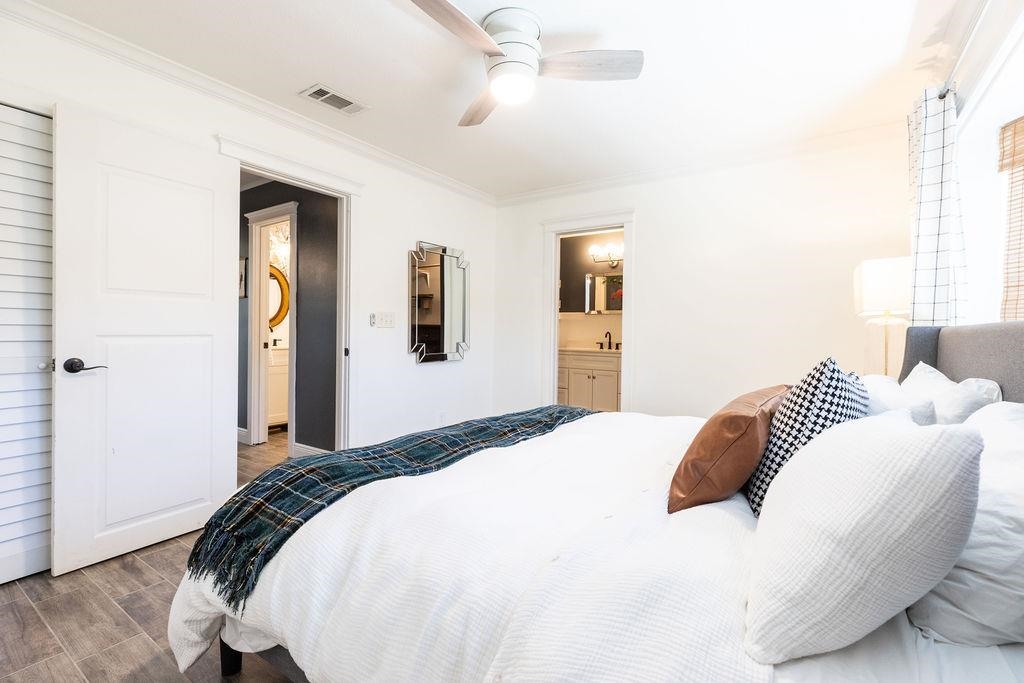 112 Drake Road St. Augustine, FL 32086 - Photo 30 of 59 a bedroom with a large bed and a chandelier