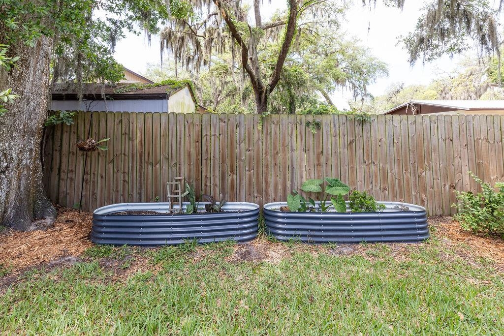 112 Drake Road St. Augustine, FL 32086 - Photo 48 of 59 a backyard of a house with a bench and some trees