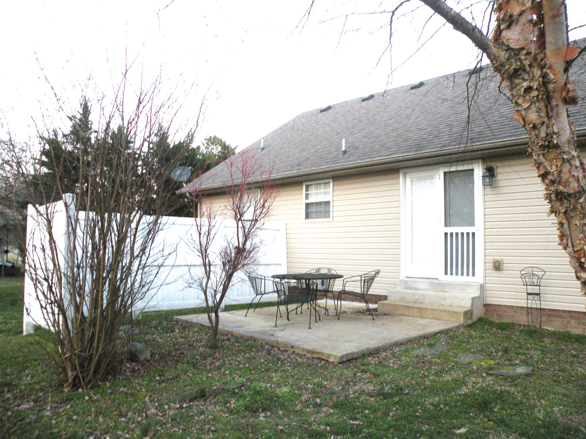 110 Harper Road Portland, TN 37148 - Photo 23 of 27 a backyard of a house with table and chairs