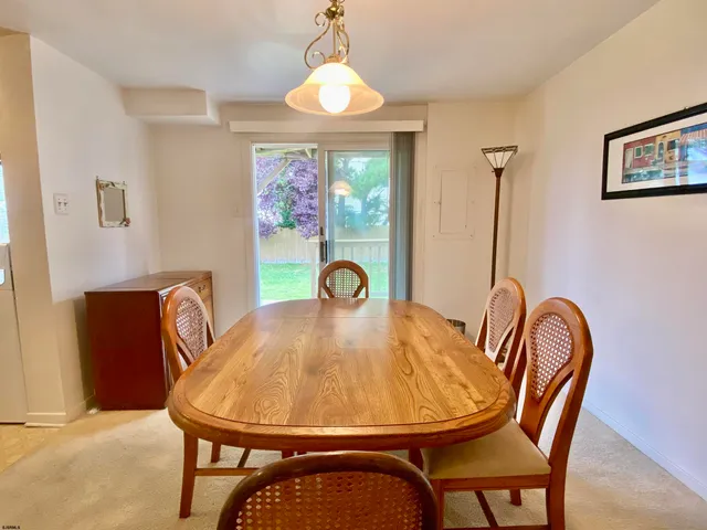 a view of a dining room with furniture and window