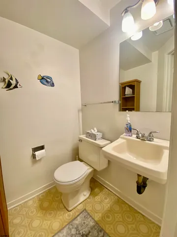 a bathroom with a sink a toilet and mirror