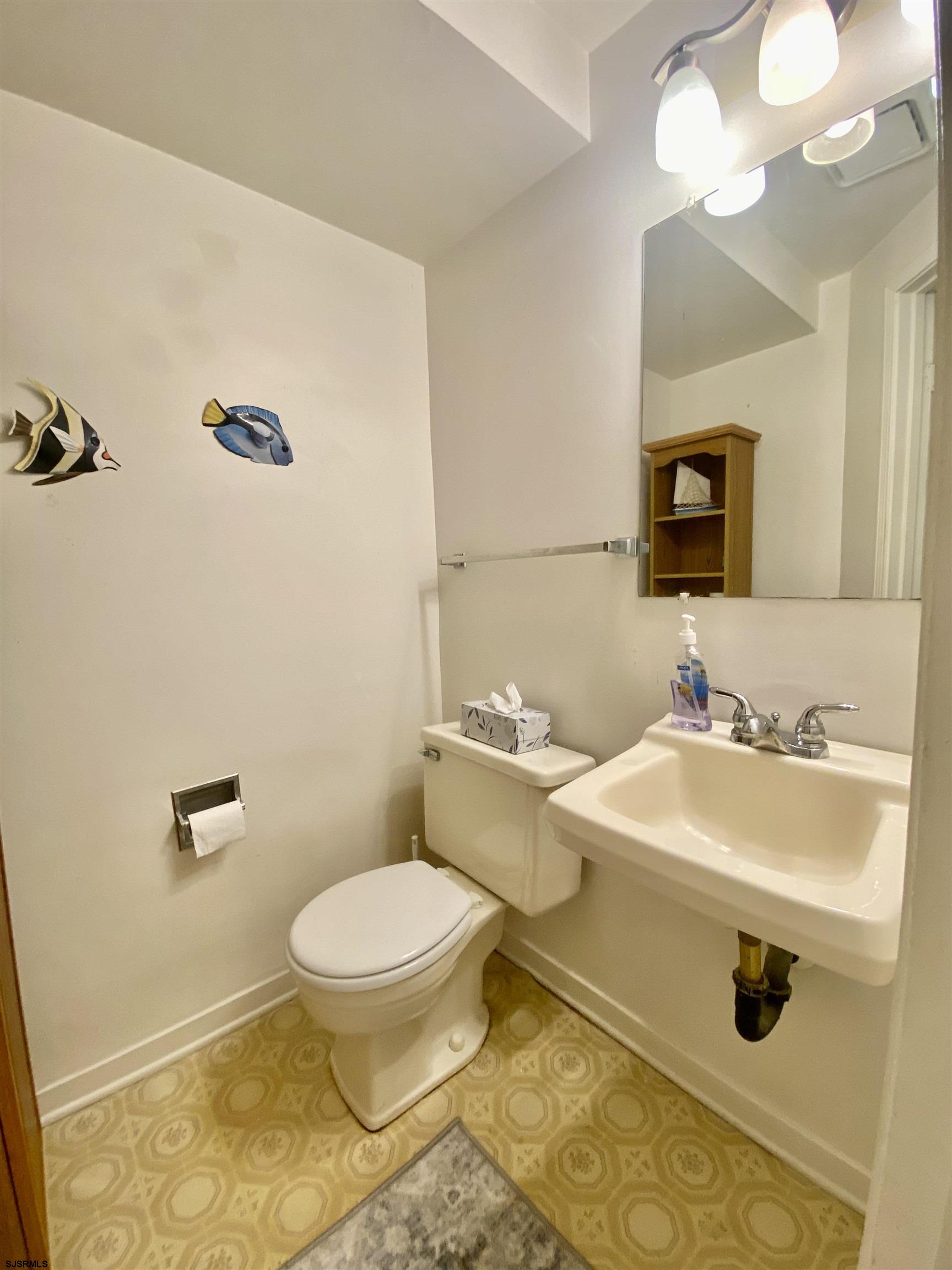 4 Ontario Drive, Unit B Brigantine, NJ 08203 - Photo 14 of 25 a bathroom with a sink a toilet and mirror