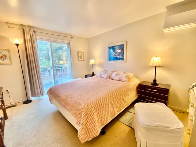 a bedroom with a bed and a night stand