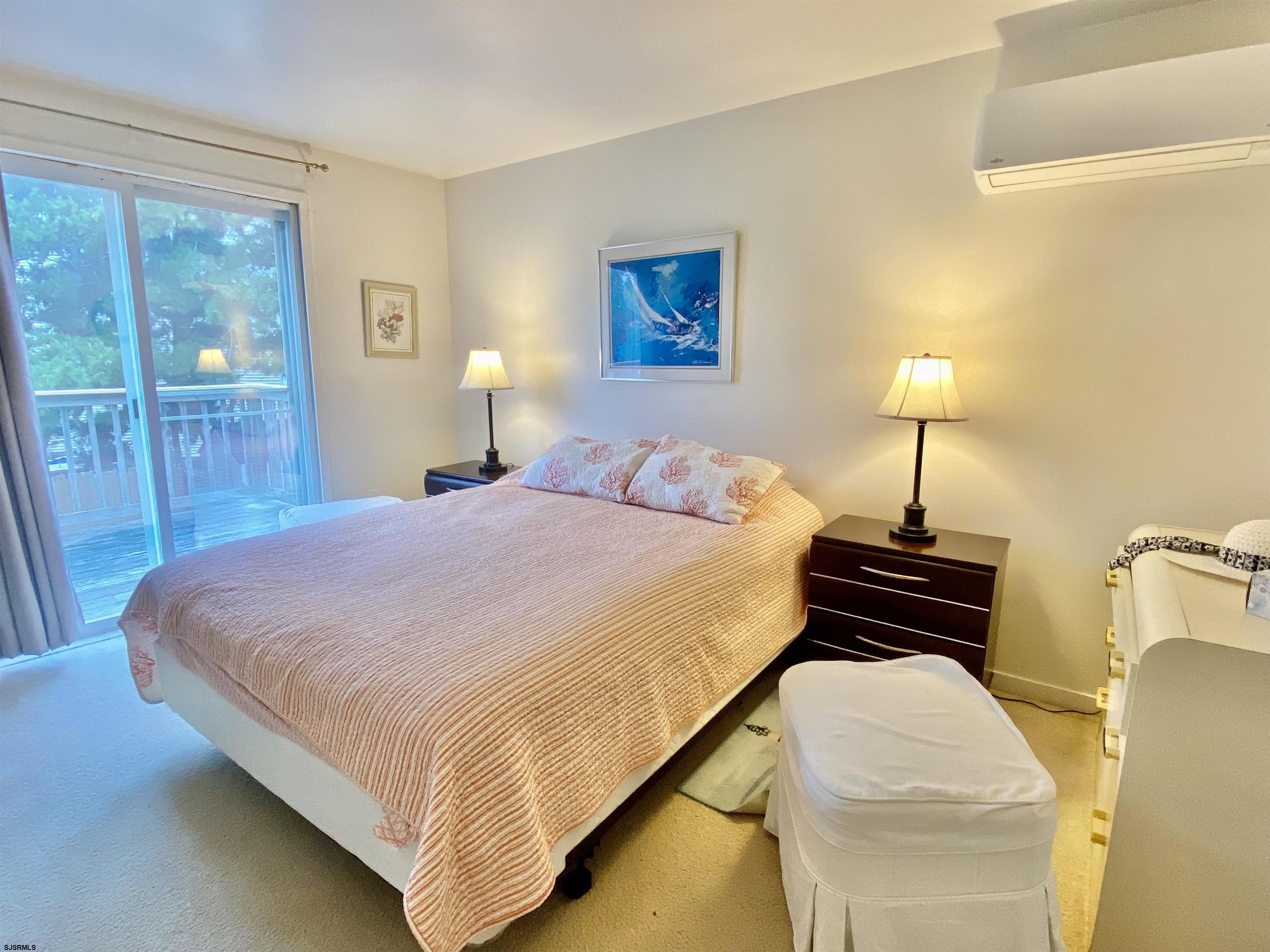 4 Ontario Drive, Unit B Brigantine, NJ 08203 - Photo 17 of 25 a bedroom with a bed and a lamp